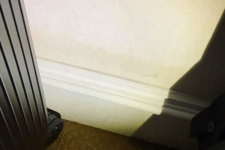 Brown stains on a closet wall showing surface mold caused by humidity in a coastal home