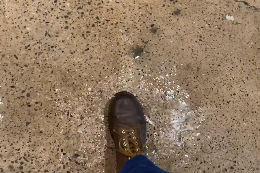 Standing water flooding the hallway of a school administration building in Orange County
